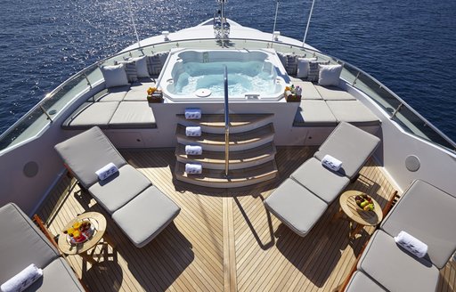The Jacuzzi and surrounding sunloungers on the sundeck of luxury yacht 'Zoom Zoom Zoom'