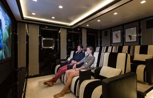 couple enjoying their privacy in a completely empty cinema room where they watch the oscar winning film parasite