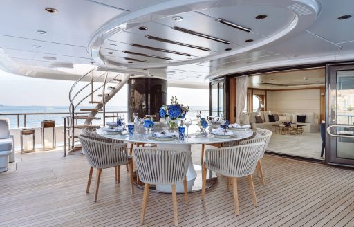 Exterior dining table on the aft deck of charter yacht SAMIRA