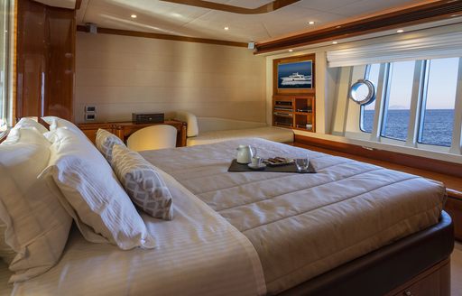 bed facing large window in the master suite on board motor yacht ASTARTE 