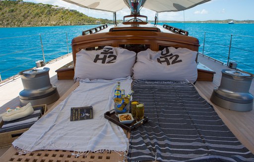 A lounging area set up under awnings on foredeck of luxury yacht RAINBOW