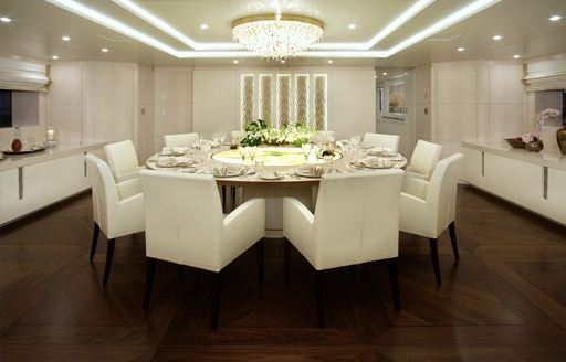 circular dining table in the main salon of luxury yacht ROMA
