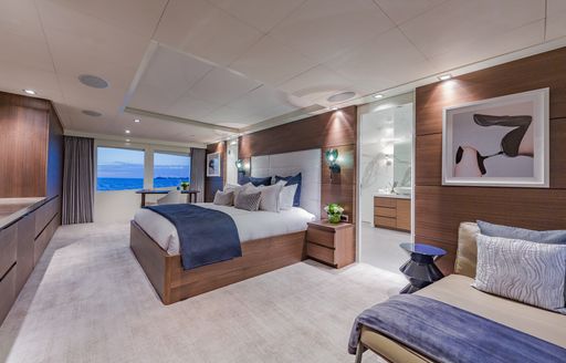Master cabin onboard charter yacht BIG SKY, central berth with large windows aft 