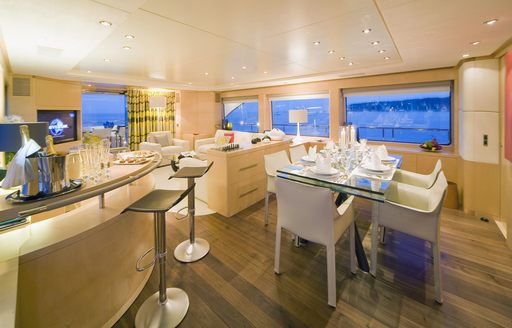 dining area and bar in main salon of luxury yacht aerial shot of yacht Salu