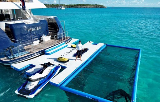 Overview of the swim platform of charter yacht PISCES with a plethora of water toys out