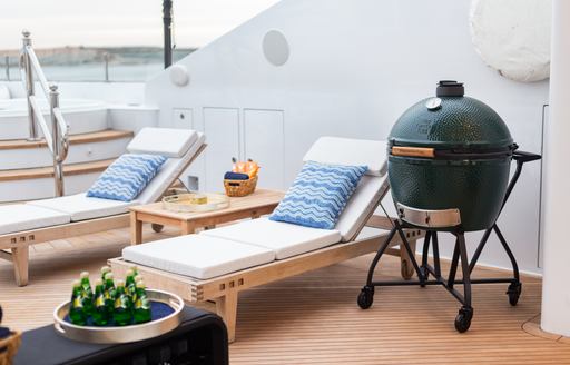Small barbeque and sun loungers onboard charter yacht PURPOSE