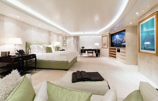 Light colored bedroom with TV and ambiant natural lighting