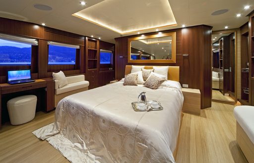 Bed with mirror above in master suite of luxury yacht Soiree