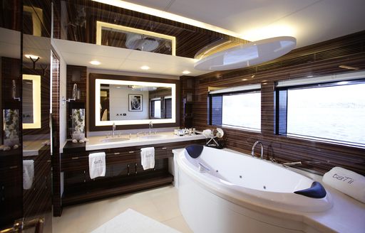 Elegant en-suite on superyacht GEMS II, with bath and long windows