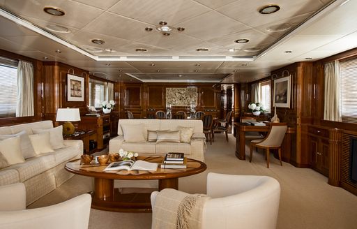 traditional lounge with dining area beyond in main salon of luxury yacht Metsuyan IV