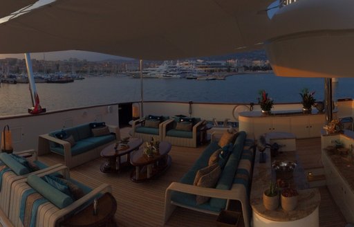 main aft deck seating and dining area on motor yacht 'Cocoa Bean'