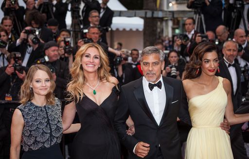 Actors Julia Roberts, George Clooney and his wife Amal Clooney on red carpet at Cannes Film Festival.