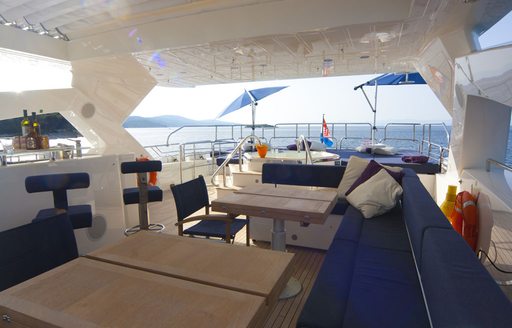 Charter yacht CASSIOPEIA sundeck with dining and sofa seating