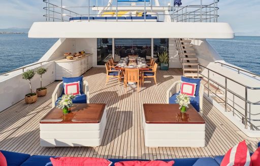 Upper deck aft of charter yacht TIMBUKTU, with alfresco dining option visible