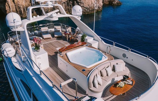 Overview of the sun deck onboard charter yacht OAK with a central Jacuzzi