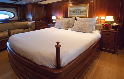 large bed in mahogany master suite on board sailing yacht ATHOS 