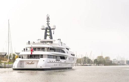 Charter yacht FIREBIRD underway along a river