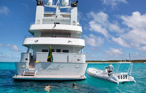 View of stern of explorer yacht MARCATO with RIB tender next to it