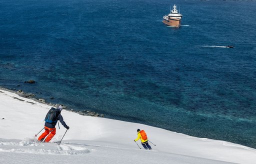 Charter yacht LA DATCHA and charter guests skiing