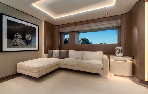 Comfortable seating on superyacht O'PARI with large photo on the wall and windows behind