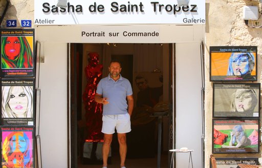A man stands in the doorway of the Sasha de St Tropez art gallery/shop, South of France