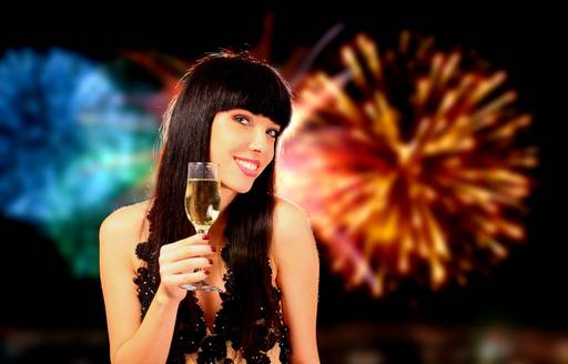 a charter guest sips champagne while watching the fireworks in Sydney Harbour
