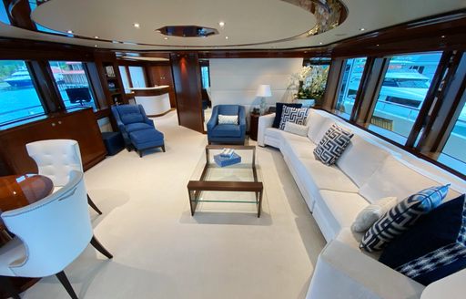 Large sofa in front of dining table on superyacht Chasing Daylight