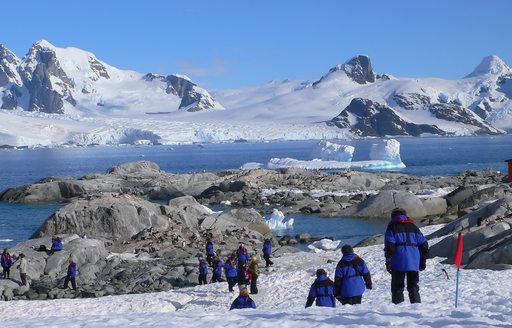 People hiking across the tundra plains in Antarctica