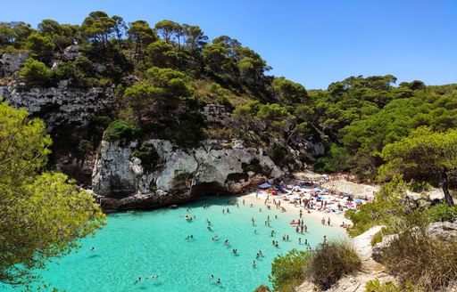 Cala Macarelleta famous paradise beach with turquoise water and pine forests on south coast of Menorca Island, Balearic Islands, Spain.