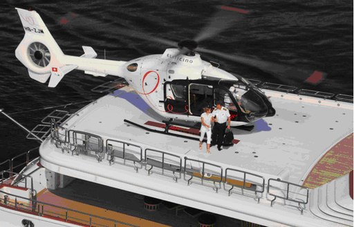 Overview of the helipad and a helicopter onboard charter yacht NOMAD