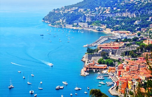 Superyachts and tenders gathered along the coastline of the French Riviera