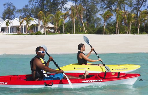 thanda's guests using kayaks in the sea around the island