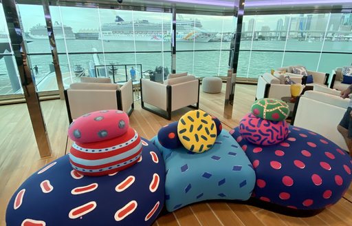 the colourful and comfortable seating inside superyacht BOLD upper deck overlooking the docks of the miami yacht show 2020 in florida