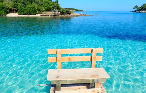 Wooden seat in clear waters of Mediterranean