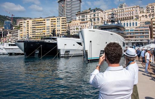 Monaco Yacht Show male visitor photographing yachts