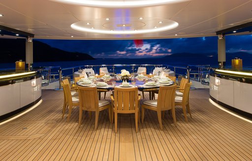 Alfresco dining setup on the aft main deck onboard charter yacht WHISPER