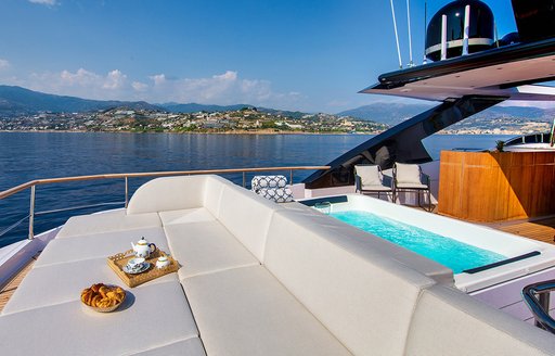 Comfortable seating with Jacuzzi behind on luxury yacht ARSANA