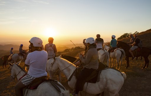 Riders enjoyers the sunset on horseback in Costa Rica