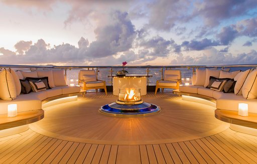 Overview of the sun deck firepit and seating area onboard charter yacht WHISPER