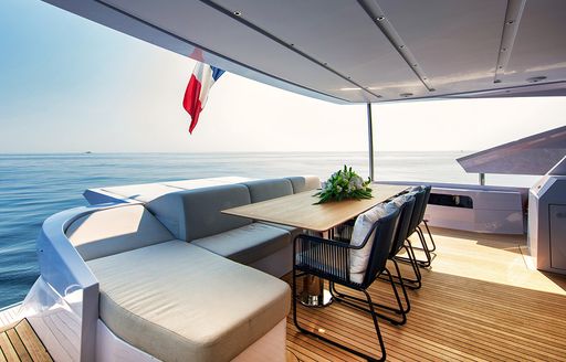 Covered outdoor dining area on luxury yacht ARSANA