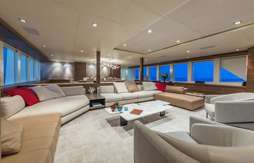 Overview of the main salon onboard charter yacht BIG SKY, spacious lounge area with large windows