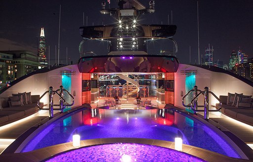 Pool area lit up at night onboard MY Kismet