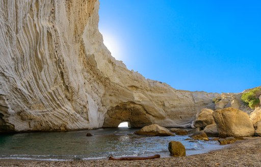 Dramatic natural feature in Mediterranean with small pool of water nearby