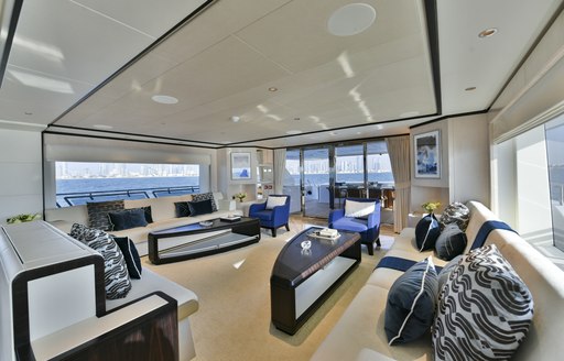 Sofas and tables in salon on Majesty 120 superyacht