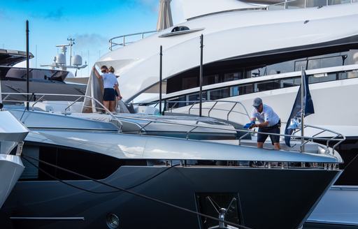 Crew on deck cleaning and tidying up yachts