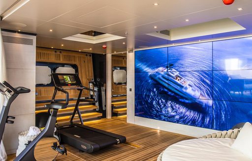 Large video wall in gym area on superyacht SEVERIN'S, with gym equipment visible