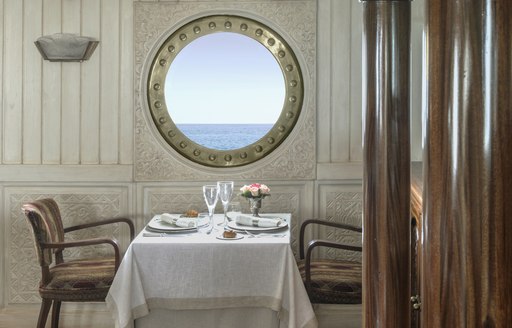 dining area and porthole on board classic yacht 'La Sultana'