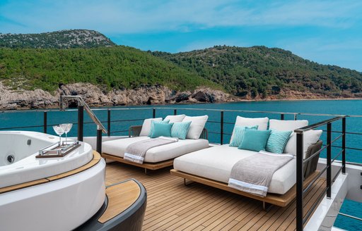 Exterior seating with teal cushions on deck of charter yacht CANOE CANOE