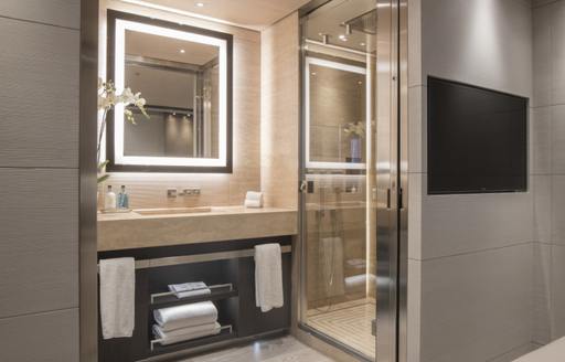 En-suite bathroom on superyacht SEVERIN'S with square mirror and shower cubicle to the right