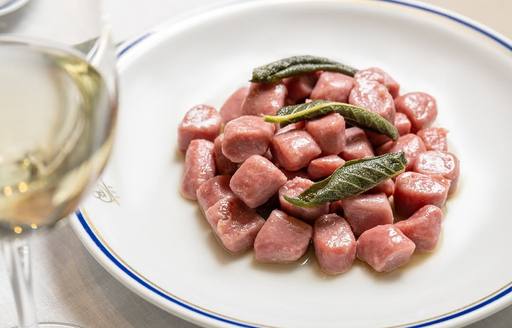 Plate of gnocchi and wine glass